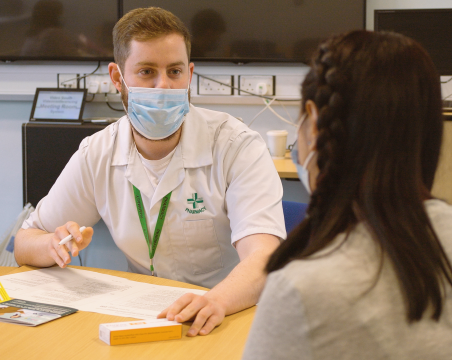 pharmacy technician talking to patient